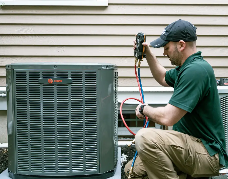 A Pespisa technician servicing an air conditioner in Chelmsford